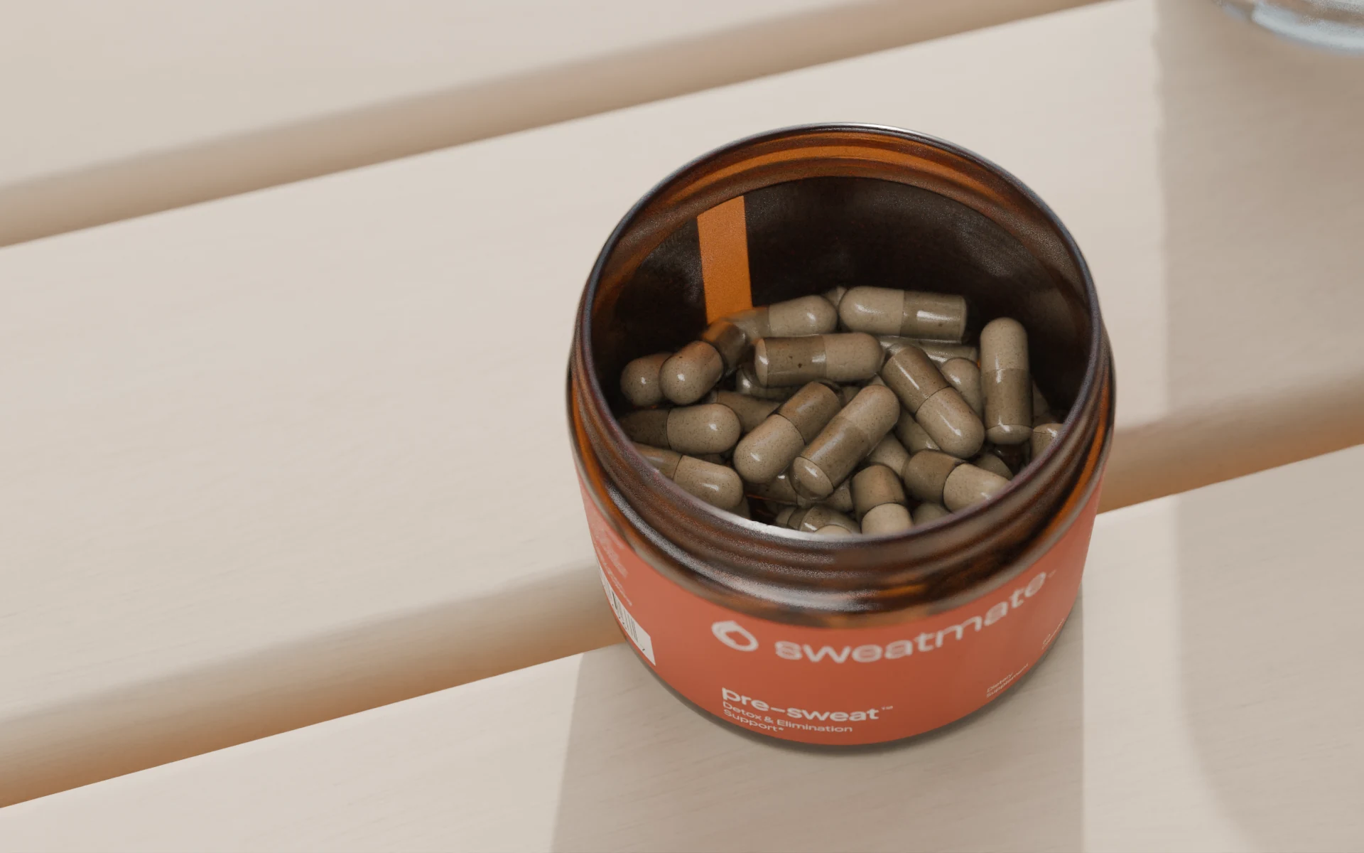 Looking down into the open amber jar, filled with cream capsules